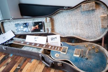 Gibson electric guitar in vintage case — New Guitar Day Setup Guide